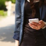 Woman Holding White Smartphone