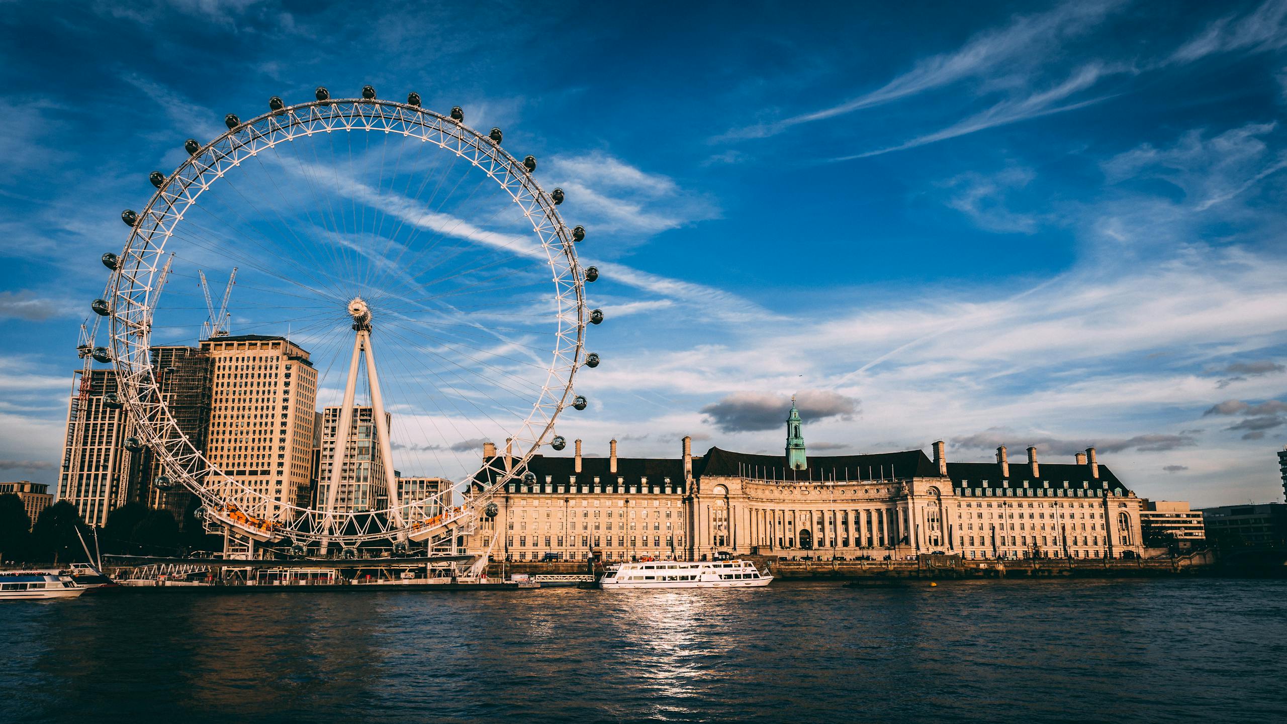 Stunning London cityscape featuring the London Eye ferris wheel by the River Thames.